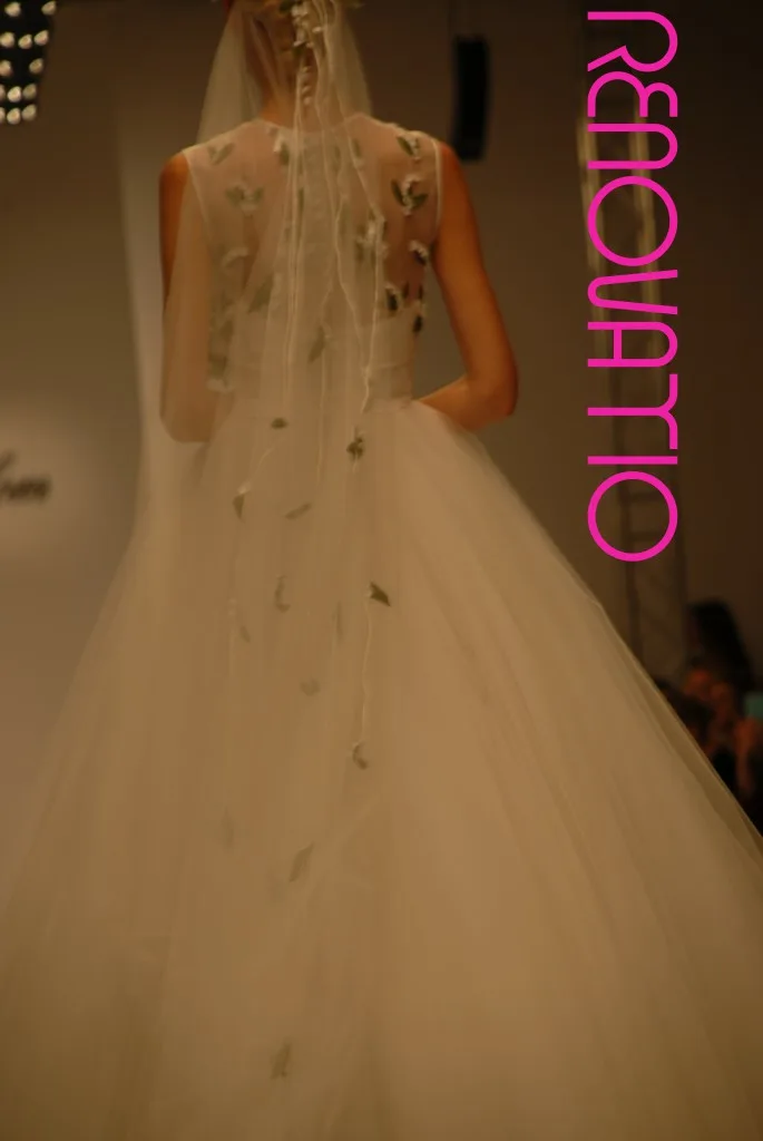 TOT-HOM COLECCIÓN O/I 16.17 Alta Costura Novias  Vestido de novia princesa de falda de volúmenes de gasa y tul blancos y velo bordado con flores blancas y hojas verdes. Cuerpo en forma de chaleco cerrado por la espalda sin mangas y diadema bordados con los mismos motivos. 